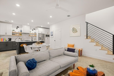 Living room with stairs, recessed lighting, baseb