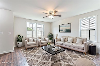 Living room with wood finished floors and ceiling fan