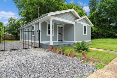 View of front of home with covered porch and a gate