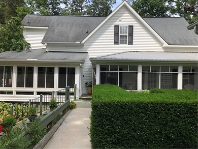 Right side of home with screened porch, sunroom, a