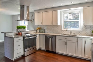 Cooking will be a pleasure in the brand new kitchen with stainless steel appliances, granite countertops, tile backsplash, new white cabinets, and recessed lighting.