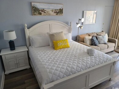 Bedroom with dark hardwood / wood-style floors