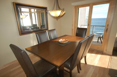 Dining area featuring a water view and light wood-