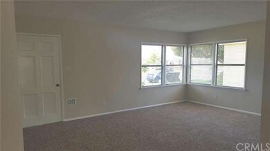 Living room has new carpet and paint.