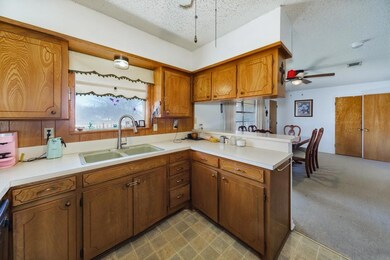 Kitchen featuring brown cabinetry, visible vents, 