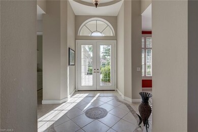 Sunlit foyer, with double entry glass doors, arche
