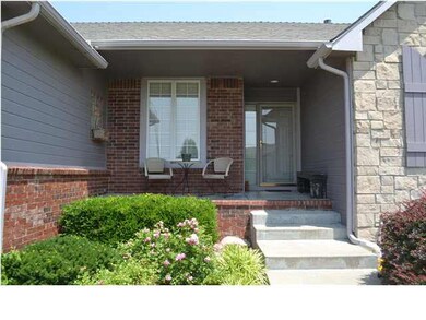 Front porch with mature landscaping.
