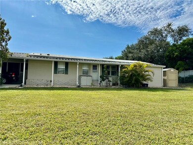 Ranch-style house featuring a front yard and a shed