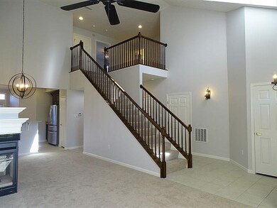 Open staircase with view of upper level loft/den