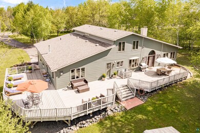 Rear view of house featuring a lawn, an outdoor ha