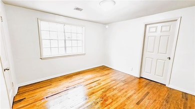 Empty room featuring light wood-style floors, visi