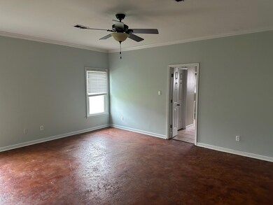 Empty room with crown molding, baseboards, and a c