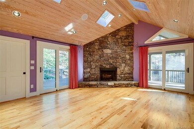 Great room with stone fireplace and cathedral ceil