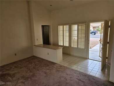 Unfurnished room with light colored carpet, a towe