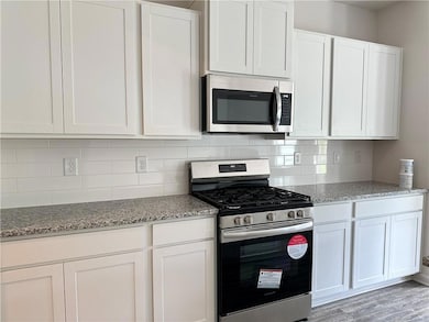 Kitchen with appliances with stainless steel finis