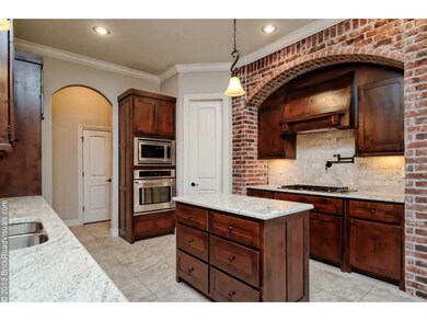 Kitchen. This kitchen really makes a statement with a signature brick archway and stainless steel appliances.