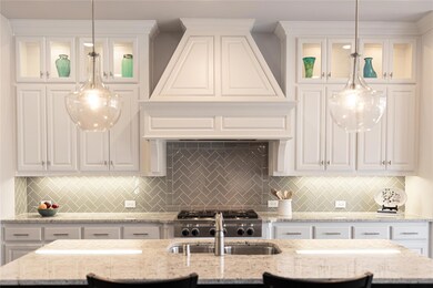 Chef's kitchen and oversized island: features a ti