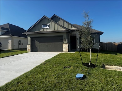 View of front of home featuring board and batten siding, stone siding, concrete driveway, and an attached garage