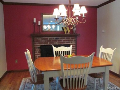 Dining room with chandelier, gas FP and hardwood f