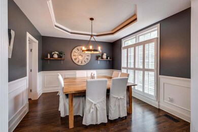 The formal dining room is located off the main entry and connected directly to the kitchen. Perfect for entertaining! Updated modern lighting and a trey ceiling. 