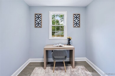 Office space with wood finished floors and baseboa