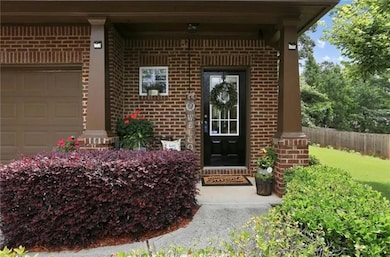 Entrance to property with brick siding and a garage