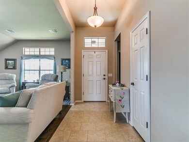Entryway with light wood finished floors and lofted ceiling