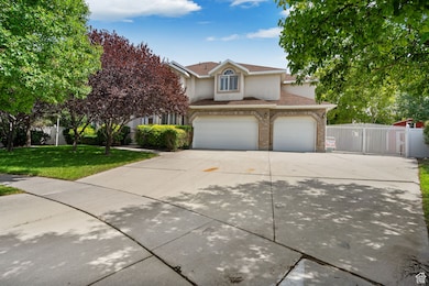 View of front of home featuring driveway, stucco siding, a gate, an attached garage, and roof with shingles