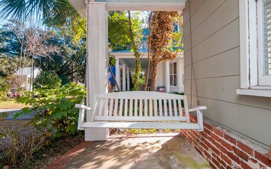 Doorway to property featuring covered porch
