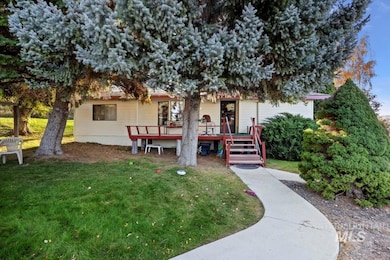 Back of property featuring a wooden deck and a lawn