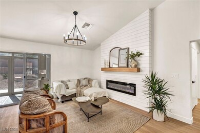 Living area featuring wood finished floors, vaulte