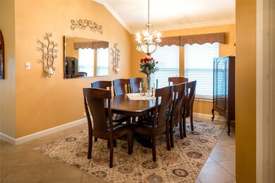 Formal dining room is light, bright, and open with sloped high ceiling.