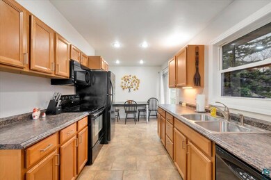 Kitchen featuring black appliances and sink