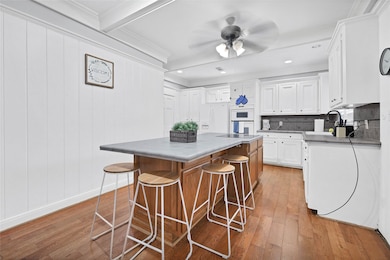 This bright kitchen features white cabinetry, a la