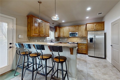 Kitchen featuring stainless steel appliances, a pe