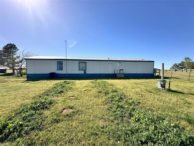 Back of house with a lawn