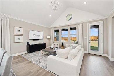 Great room with vaulted ceiling and chandeliers
