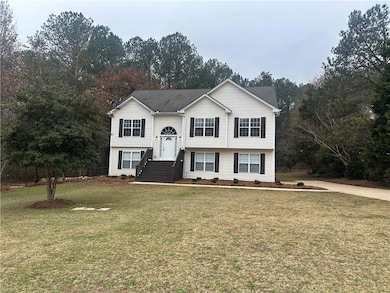 Raised ranch featuring a front lawn