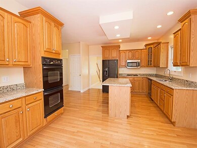 The spacious kitchen sports newer granite, stainle