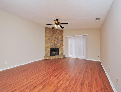 Living room w/ wood burning fireplace