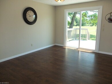 Dining room with wood flooring and slider to back 