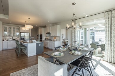 Dining area with an inviting chandelier, dark hard