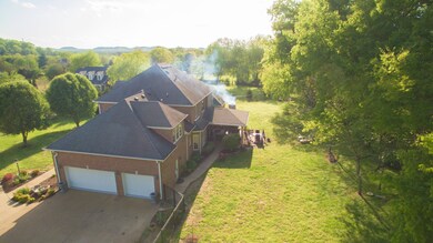 Private and level yard with mature trees and full fence.  Three Car Spacious Garage with Built-in Cabinet Area.