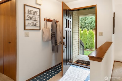 A sunlit entry opens to soft views of the surrounding greenery bringing a hint of the home’s pastoral setting indoors.