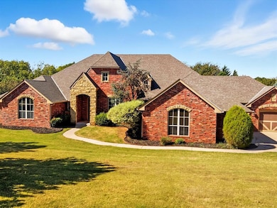View of front of home with a shingled roof, a front yard, and brick siding