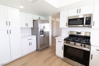 Kitchen featuring stainless steel appliances, ligh