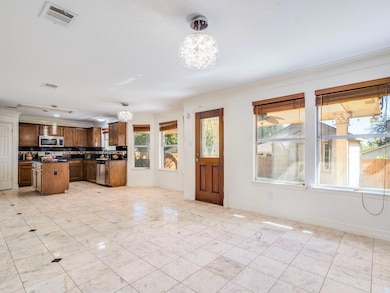 Kitchen with dark countertops, a chandelier, hang