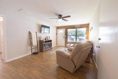 Living room with ceiling fan and wood finished floors