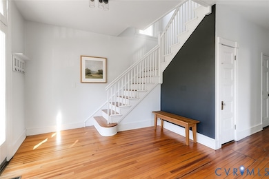 Stairway featuring hardwood / wood-style floors