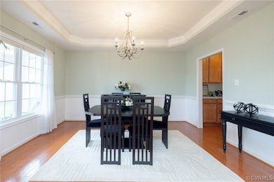 Dining room with an inviting chandelier, hardwood